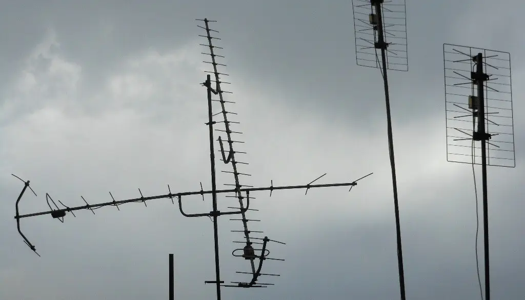 A rooftop television antenna pointed at the sky, used to receive over-the-air broadcast channels
