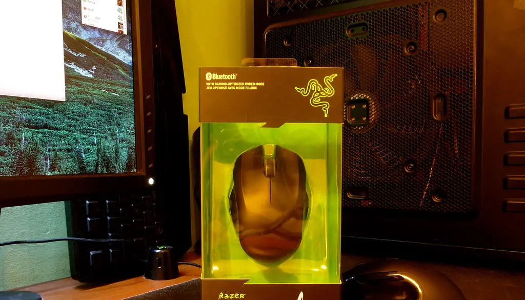 A lightweight wireless gaming mouse resting on a desk mousepad