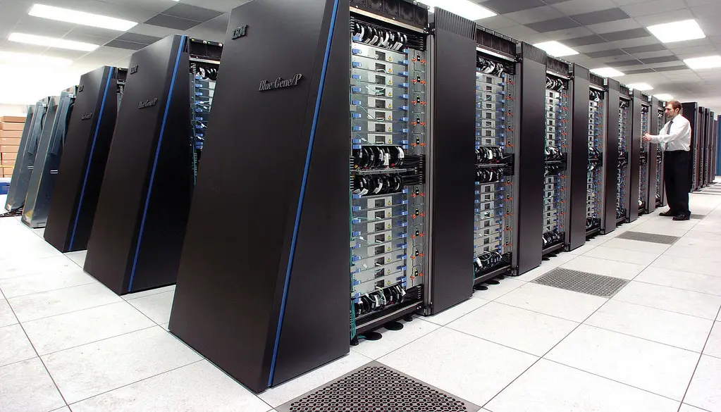 Long rows of supercomputer cabinets in a data center hall