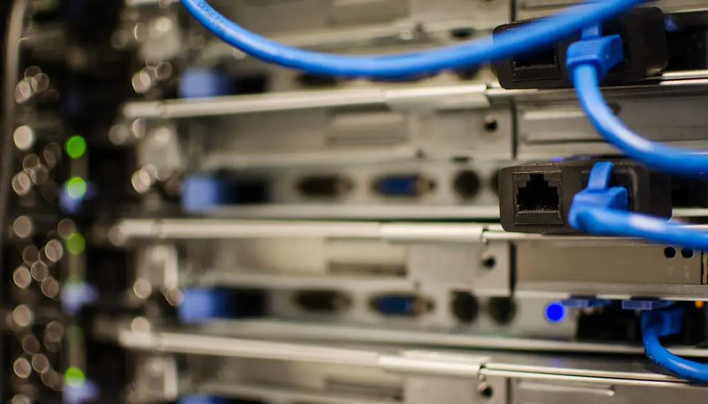Rows of network equipment and cabling inside a data center