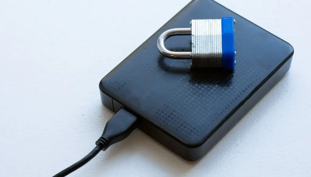 Illustration of an encrypted laptop drive protected by a lock
