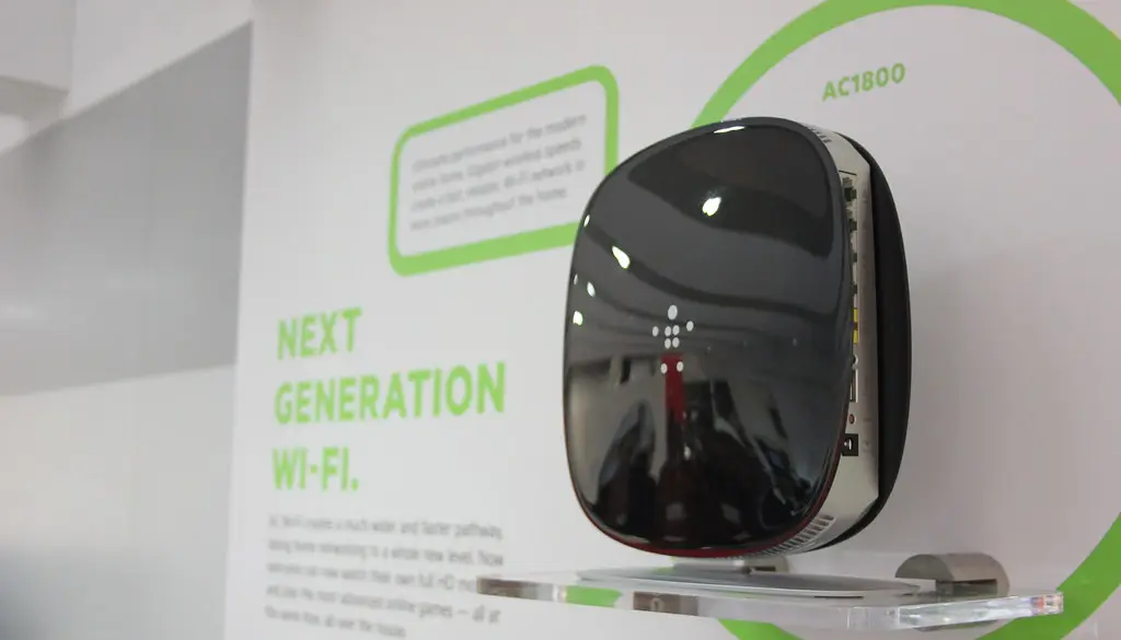 A dual-band Wi-Fi router on a shelf in a living room