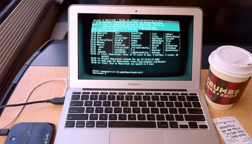 A Mac laptop showing a terminal with an SSH connection to a remote machine