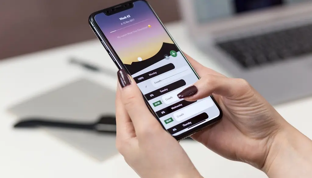 A person holding a smartphone with a private messaging conversation open