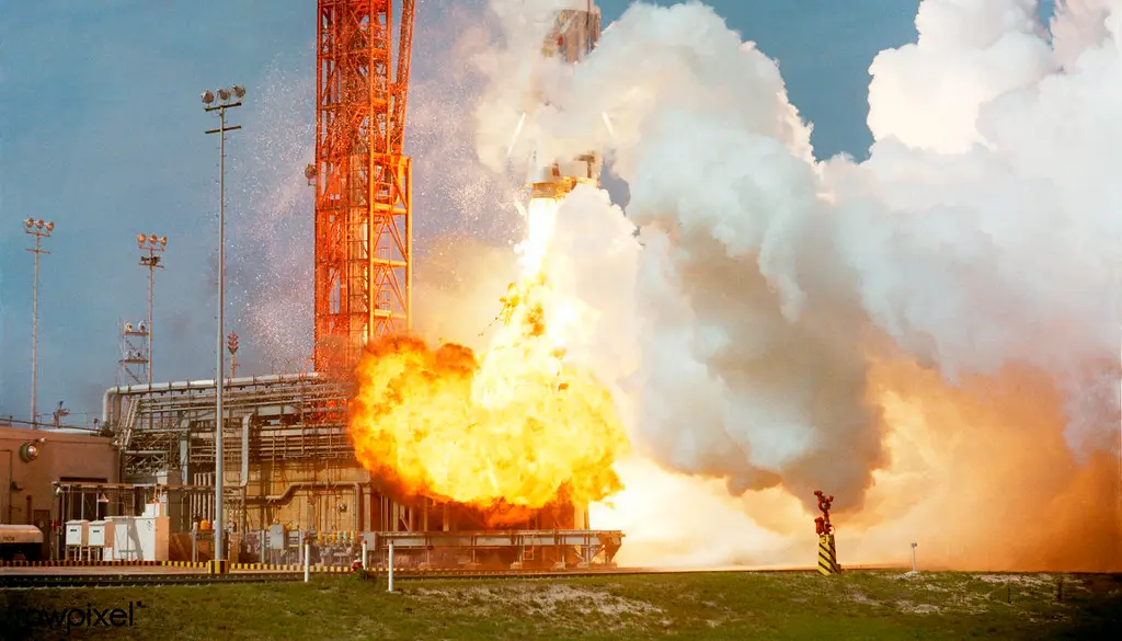 A rocket lifting off from a launch pad with bright exhaust