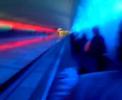 Streaks of fast-moving light racing through a dark tunnel suggesting acceleration